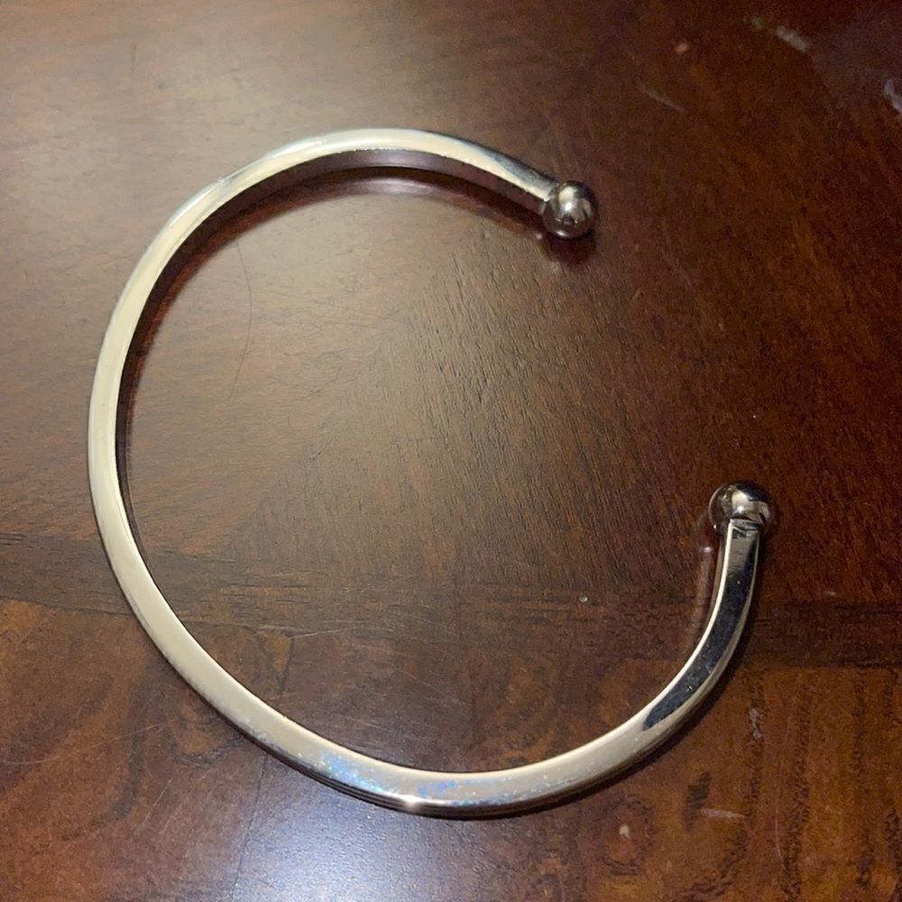 Avon silver tone open end bracelet
